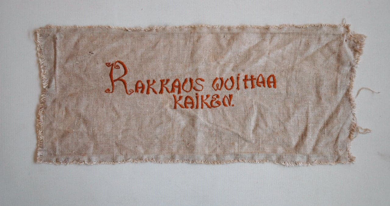 Embroidered wall hanging “Love Conquers All”